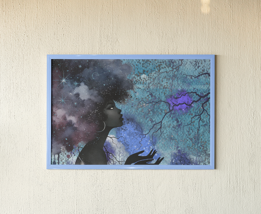 Framed artwork of a silhouette against a cosmic background on a beige wall.